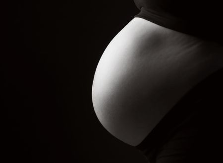 Black and White Profile of a Pregnant Woman's Bellyの写真素材