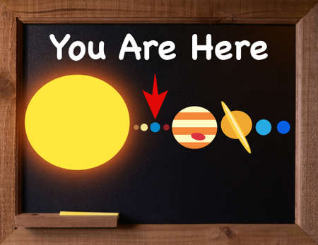 The solar system depicted on a black chalkboardの写真素材