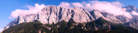 View of Zugspitze Mountains seen from bank of Lake Eibsee with pink filterの写真素材