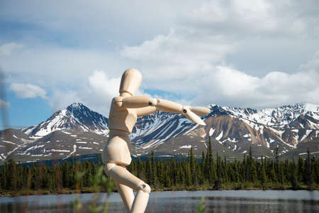 Wood drawing mannequin in front of rocky mountains in Alaska.の写真素材