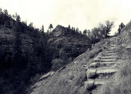 Hike up Rugged terrain in Gila Cliff Dwellings National Monument in black and white
