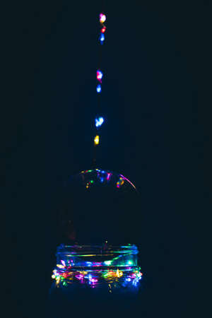 LED lights leading to glass lens ball, with reflection of lights and blue purple background.の写真素材