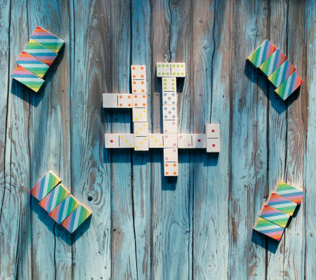 Game of Dominoes played on wood table and brightly color Dominoes.の写真素材