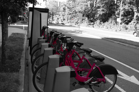 Bike station for a bike-share program along a road.