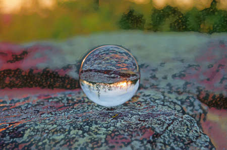 Shenandoah national park Sunset is reflected in a Crystal Ball, resting on a flat rock.の写真素材
