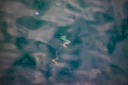 Blue water surface with a reflection of the sun. Abstract background.の写真素材