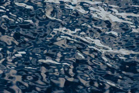 Blue water surface with ripples. Abstract background and texture for design.の写真素材