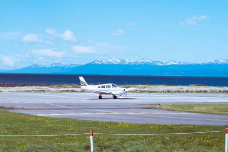 Small airplane on the runway with mountains in the background. Iceland.の写真素材