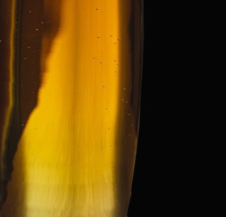 Detail of a bottle of beer isolated on a black background.の写真素材