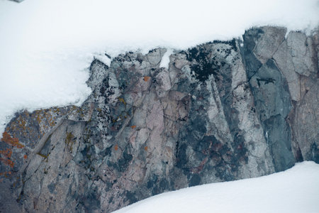 Rocky landscape with snow and ice on the slopes of the mountainの写真素材