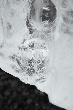 Close up on bubble texture created in iceberg laying on the beach in Antarctica.の写真素材