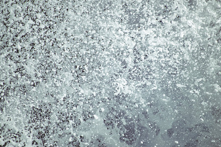 Close up on ocean spray coming off an ocean wave.