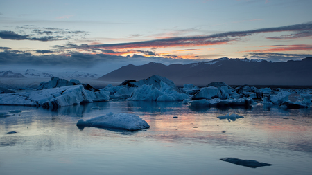 Jokulsarlon, glacier lagoon in Iceland at night with ice floating in water. Cold arctic nature landscape scenery. Ice melting.の写真素材