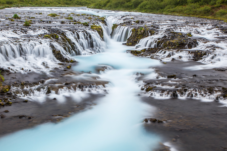 Detail of bright powerful Bruarfoss waterfall in Iceland with cyan water blurred by long exposure. Popular tourist attraction. Unusual and picturesque scene. Location place South Iceland, Europe. Artistic picture. Beauty world.の写真素材