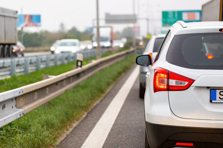 White car waiting in traffic jam on highway in rush hour.の写真素材