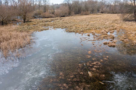 Frozen floodplain from drone perspective in winter.