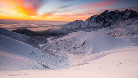 Panorama of snowy mountains in wintertime in sunriseの写真素材