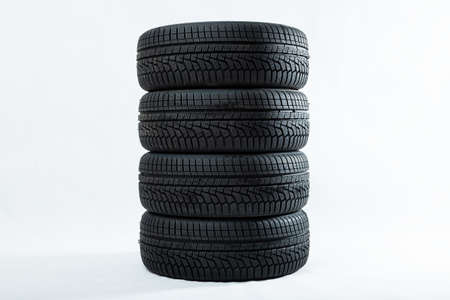Stack of winter tires with specific structure and deep ridges shot in studioの写真素材