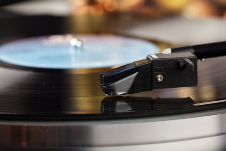 Turntable where you see the pickup closely with shallow depth of field.