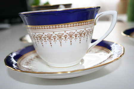 Fine China teacup with gold trim and a saucer.の写真素材