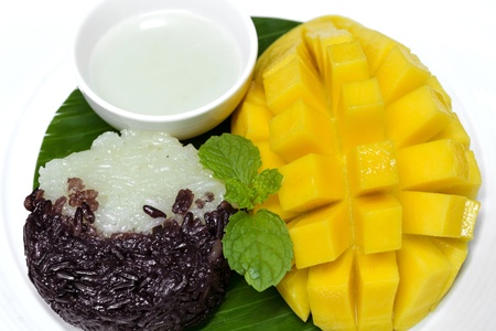 Black and white sticky rice with mango decorate with mintの写真素材