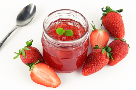 fresh strawberry jam in glass bottle with mint leafの写真素材