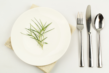 white plate on white background decoration with spoon and forkの写真素材