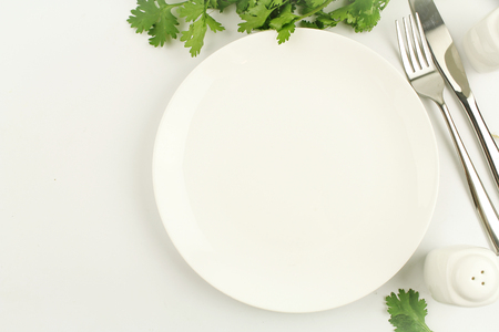 white plate on white background decoration with spoon and forkの写真素材