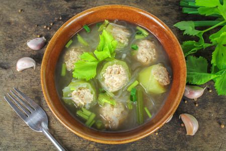 clear soup with cucumber, chicken and celeryの写真素材