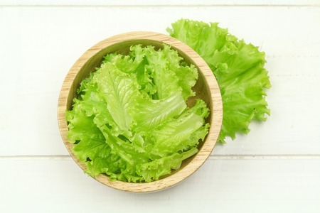 Salad leaf. Lettuce isolated on wooden backgroundの写真素材