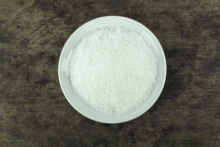 Sugar in glass bowl isolated on white