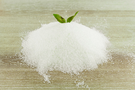 Heap of granulated sugar isolated on whiteの写真素材