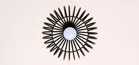 Black decorative lamp hanging from the ceiling, modern lamp on white backgroundの写真素材