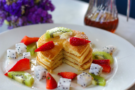 Pancakes for breakfast topped with strawberry and kiwiの写真素材