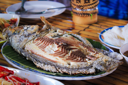 Grilled Tilapia fish on plate at restaurantの写真素材