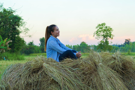 women farmer in ripe wheat field planning harvest activityの写真素材