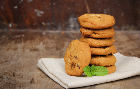Oatmeal raisin cookie isolated on a wooden backgroundの写真素材