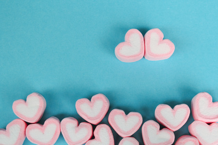 marshmallow heart shape with love concept on blue backgroundの写真素材