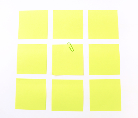 yellow sticky note isolate on white backgroundの写真素材