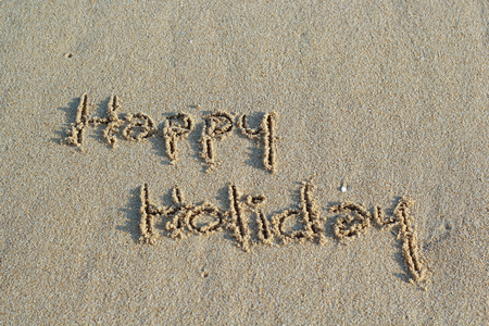 Hello Holidays. written in sand at the beachの写真素材