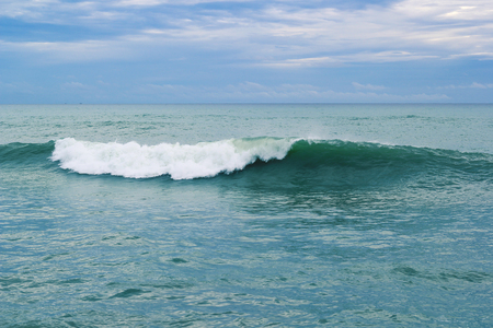 Blue ocean waves breaking on a stormy day natural backgroundの写真素材
