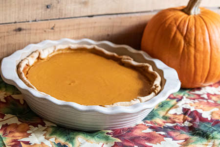 Focus on pumpkin pie in the foreground with pie pumpkin in the background out-of-focus.の写真素材