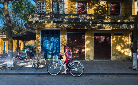 Hoi An, Vietnam - January 29 2017 - Bicycle girl getting ready to ride around the street of Hoi An ancient town.  Best means of transport to get around quick and easy..のeditorial素材