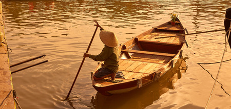 Hoi An, Vietnam, Boat man paddler in the golden hourの写真素材