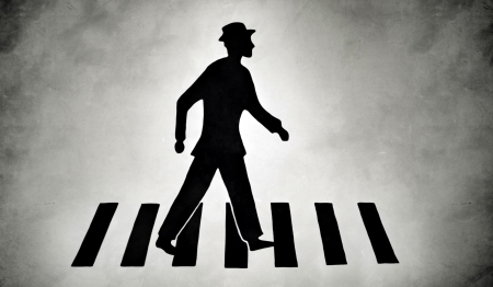 Silhouette of a pedestrian on zebra crossing streetの写真素材
