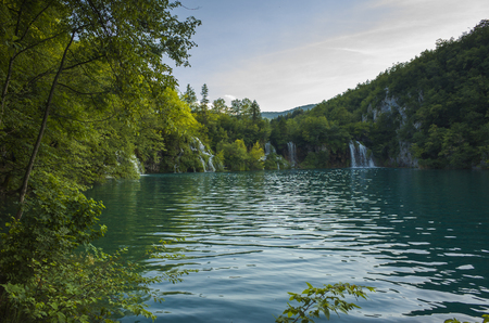 Plitvice Lakes Croatia Europe. Beautiful nature and landscape photo. Nice warm summer day. Lovely outdoors image with lake, trees and waterfalls. Joyful and happy picture.の写真素材