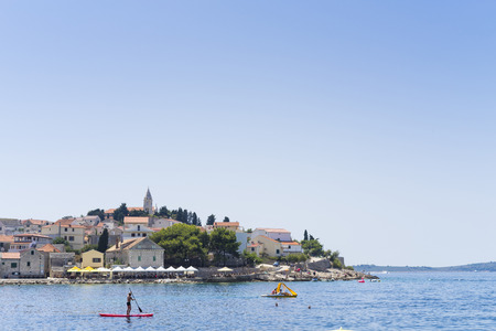 Primosten, Croatia, August 5 2017, Man on surfboard in the sea, Nice warm summer day with blue sky and ocean.のeditorial素材