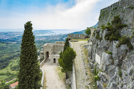 Fortress of Klis outside city of Split in Dalmatia Croatia. Beautiful old ruins and Buildings on high mountain top over the Adriatic Sea. Nice architecture of stone constructions. Ancient Royal Castleのeditorial素材