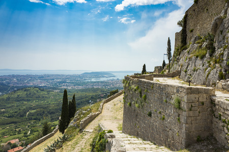 Fortress of Klis outside city of Split in Dalmatia Croatia. Beautiful old ruins and Buildings on high mountain top over the Adriatic Sea. Nice architecture of stone constructions. Ancient Royal Castleの写真素材
