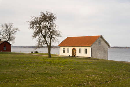 Bjorkvik, Sodermanland, Sweden - 04 04 2021 : Old house and lake on spring day.のeditorial素材